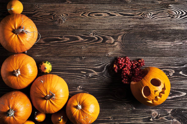 istock Halloween pumpkins over wooden background 842772758