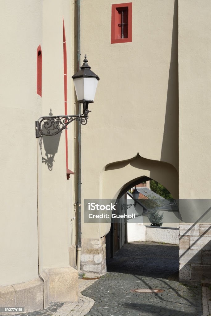 Torweg Hof sidewalk with an archway at the facade of a church named Michaeliskirche in Hof, Bavaria Arch - Architectural Feature Stock Photo