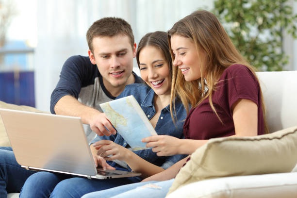 istock Three friends planning travel at home 842785742