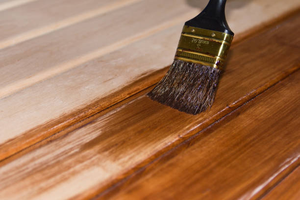 istock Painting a wooden surface with brushes and paint , copy space . 842789170