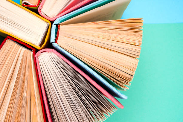 istock Top view of bright colorful hardback books in a circle. 842789462