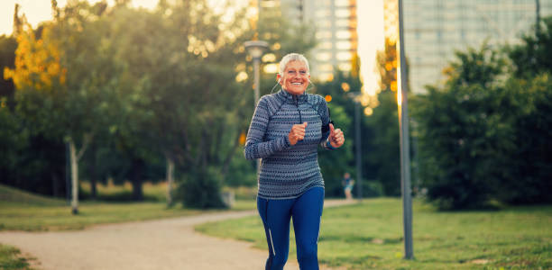 istock Senior woman jogging in the park 842793402