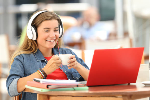 istock Relaxed student watching media in a laptop in a bar 842794176