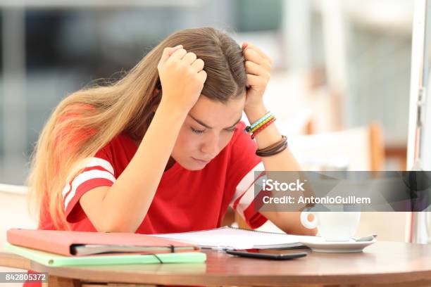 Frustrated Student Trying To Understand Notes In A Bar Stock Photo - Download Image Now