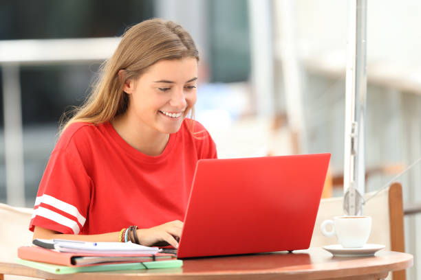 istock Happy student typing in a laptop in a bar 842805890