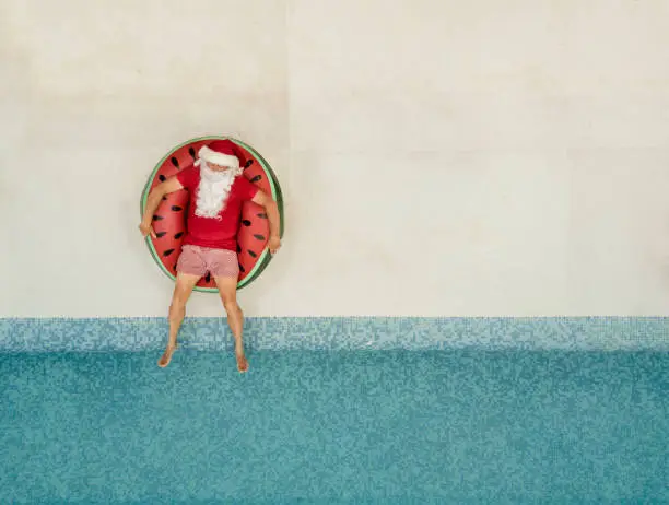 Photo of Santa Claus relaxing at the pool