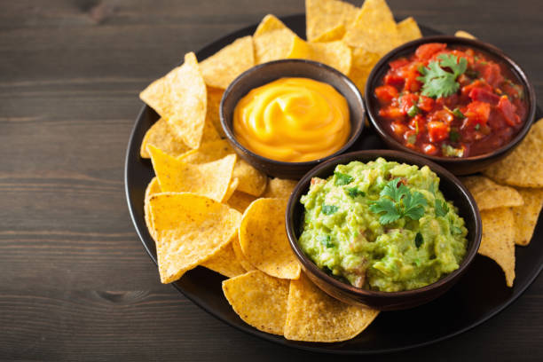 istock mexican nachos with guacamole, salsa and cheese dip 842809906