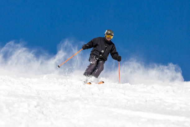 istock Male skier skiing at ski resort 842809916