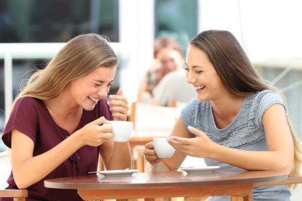 istock Best friends laughing loud during a conversation in a bar 842810614