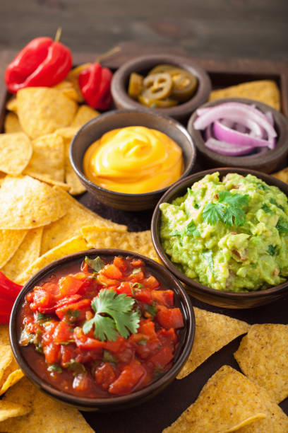 istock mexican nachos with guacamole, salsa and cheese dip 842810880