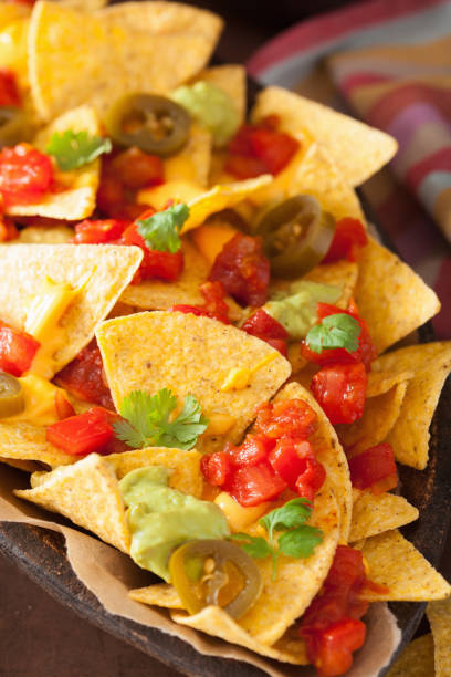 istock nachos loaded with salsa, guacamole, cheese and jalapeno 842811440
