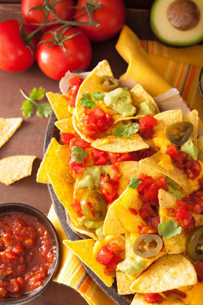istock nachos loaded with salsa, guacamole, cheese and jalapeno 842811580