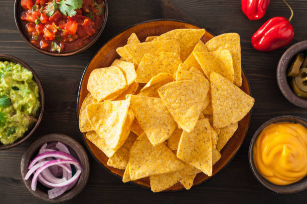 istock mexican nachos tortilla chips with guacamole, salsa and cheese dip 842814386