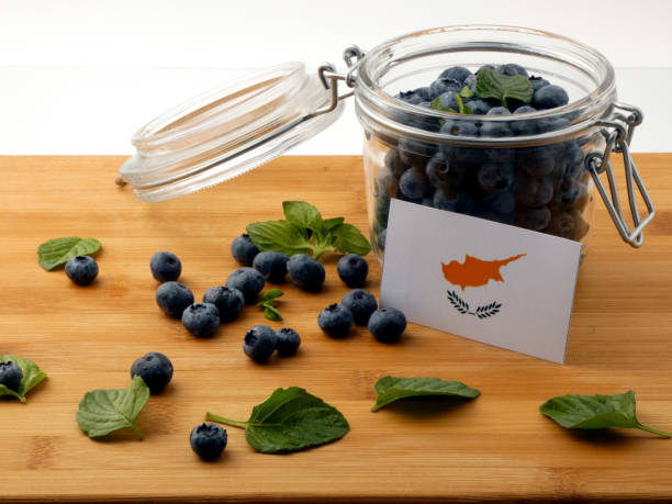 istock Cypriot flag on a wooden plank with blueberries isolated on white 842817668