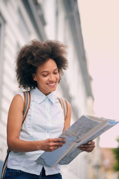 istock African American tourist looking at map 842820176