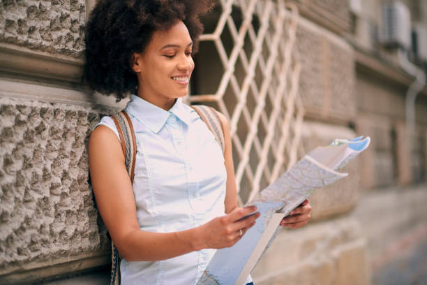 istock African American tourist looking at map 842820356