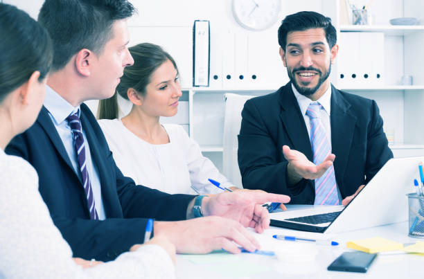 istock Businessman with partners in office 842825726