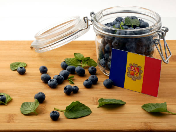 istock Andorra flag on a wooden plank with blueberries isolated on white 842825852