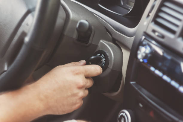 istock man's hand starts a car with the key in retro toning 842829456