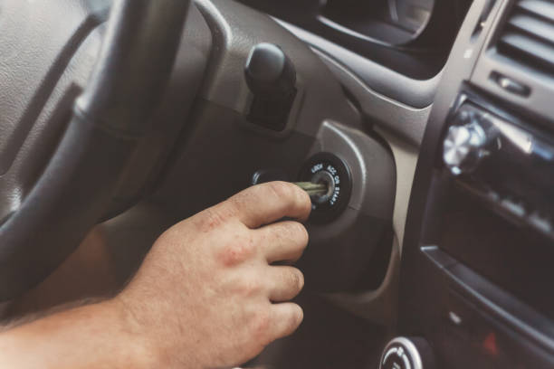 istock man's hand starts a car with the key in retro toning 842829462
