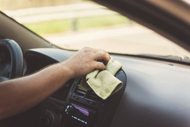 istock A man's hand wipes a carpet with a rag in a retro tint 842829466