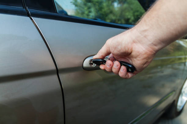 istock man's hand opens the car door with a key 842829482