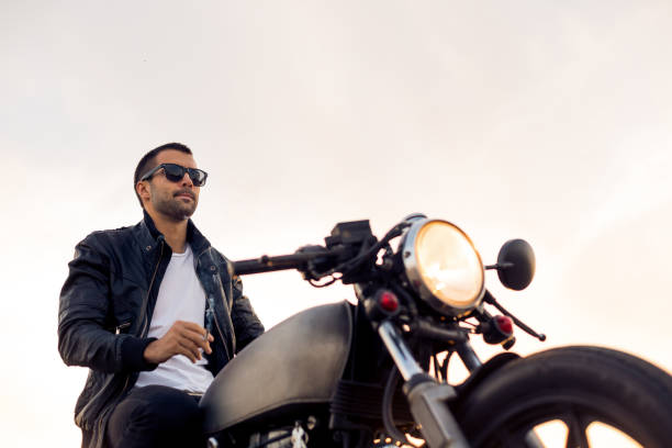 istock Brutal man sit on cafe racer custom motorbike. 842829554