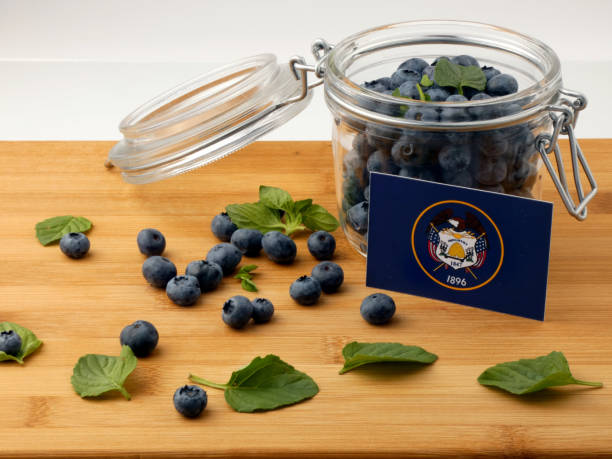 istock Utah flag on a wooden plank with blueberries isolated on white 842832734