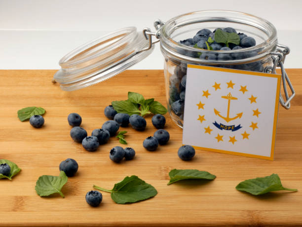 istock Rhode Island flag on a wooden plank with blueberries isolated on white 842832776