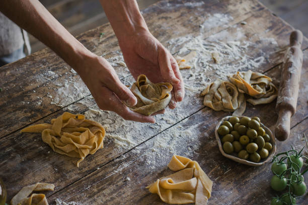istock The young man prepares homemade pasta on the old kitchen table 842836736