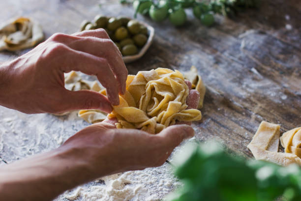 istock The young man prepares homemade pasta on the old kitchen table 842836844