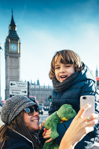 Mother and son using mobile phone near Big Ben