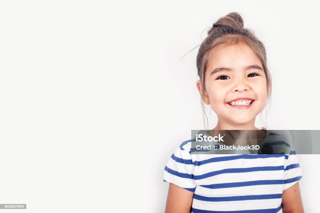 Happy Small Girl Happy small girl on the grey light background in the studio. White Background Stock Photo