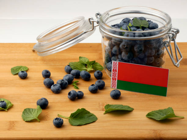 istock Belarus flag on a wooden plank with blueberries isolated on white 842844942