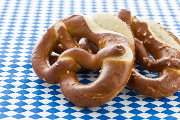 istock Freshly baked pretzels on a white-blue Bavarian tablecloth 842848344