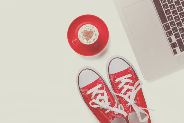 istock Computer and cup of coffee near gumshoes 842848544