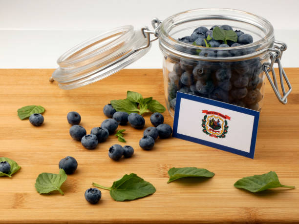istock West Virginia flag on a wooden plank with blueberries isolated on white 842848604