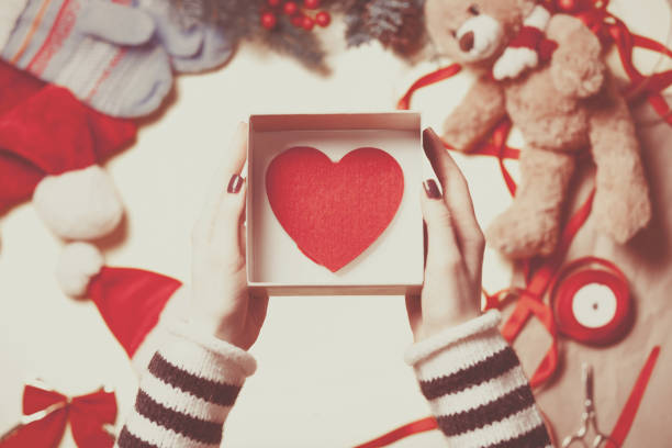 istock Woman wrapping a heart shape toy 842849148