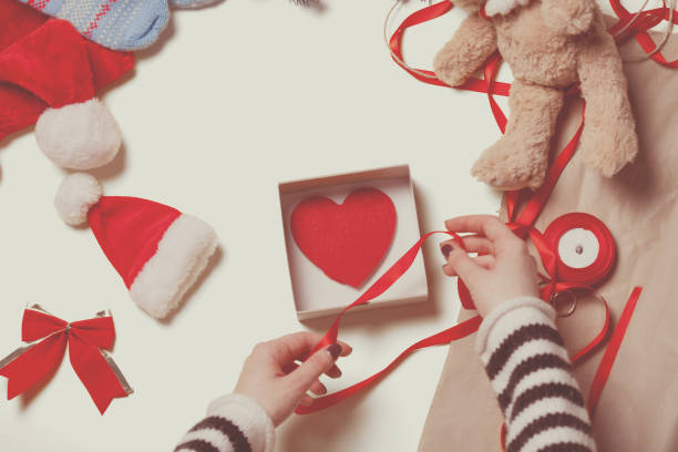 istock Woman wrapping a heart shape toy 842849182