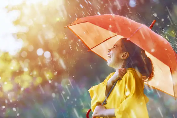 Photo of child under autumn rain