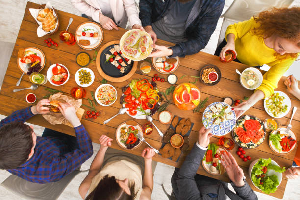 istock People eat healthy meals at served table dinner party 842852816