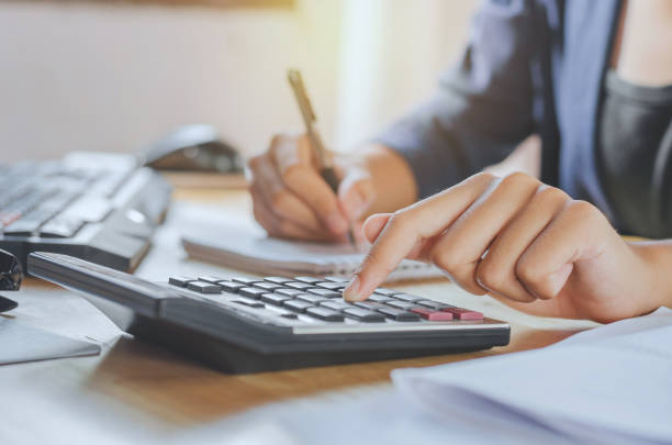 istock businessman using calculator on desk office business financial accounting concept 842853036