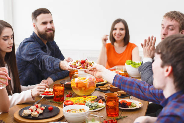istock Group of happy people at festive table dinner party 842853146