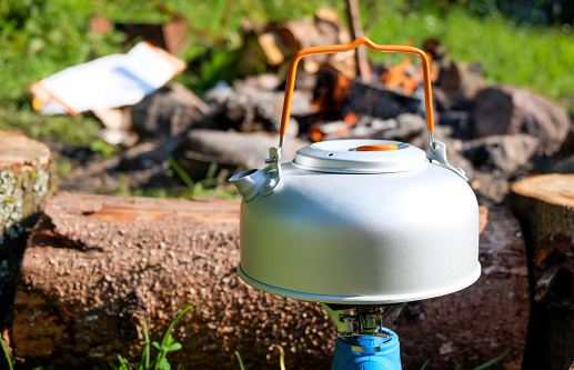 Aluminium teapot on the gas stove