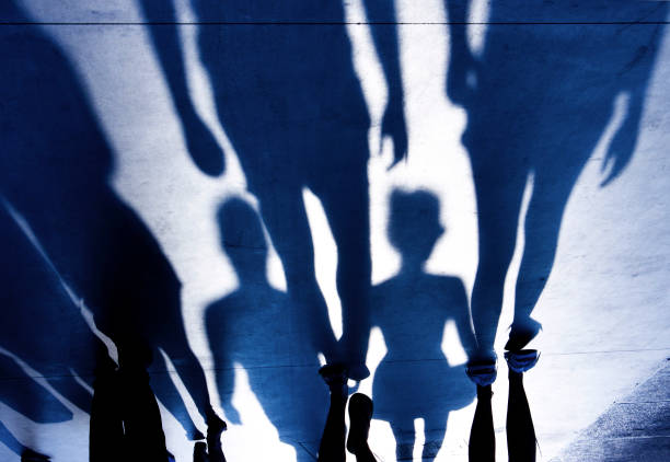 istock Blurry shadows of people walking on summer promenade 842853242
