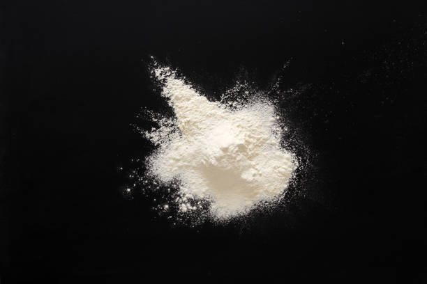 istock Sprinkled wheat flour splash spots on black background 842853308