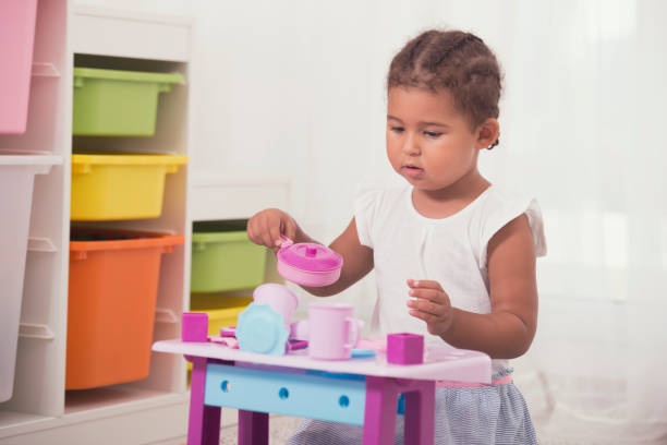 istock Little girl playing with kitchen toys. 842857926
