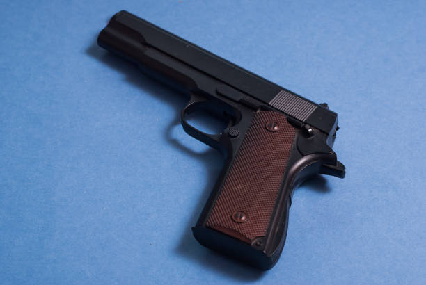 istock Gun isolated on a blue background, firearms 842861972