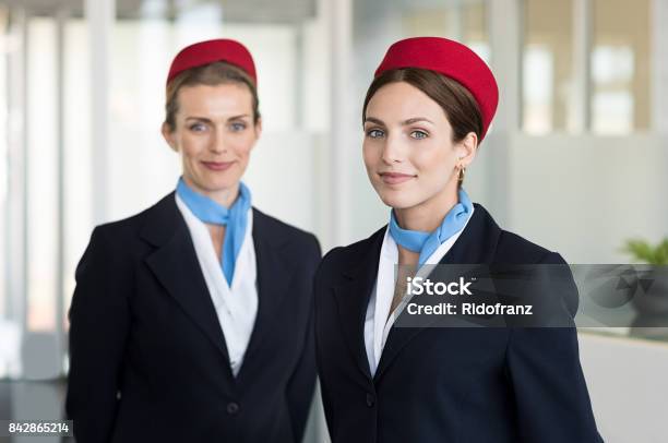 Smiling Hostess At Airport Stock Photo - Download Image Now - Cabin Crew, Airport, Air Stewardess