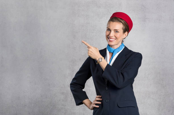 smiling air hostess showing - airplane air vehicle business travel passenger imagens e fotografias de stock